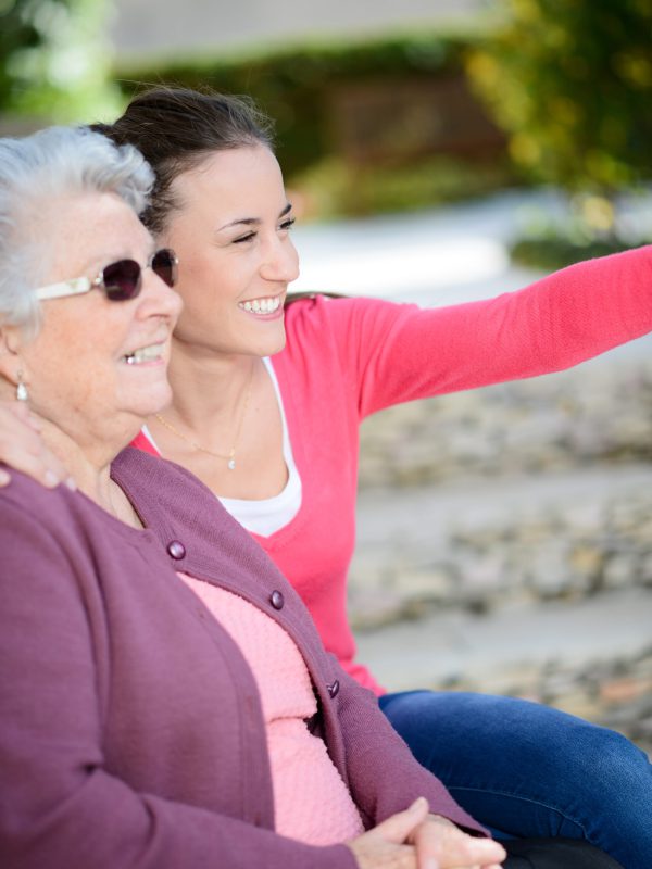 Cheerful,Old,Woman,In,Wheelchair,With,Her,Young,Granddaughter,Outdoor